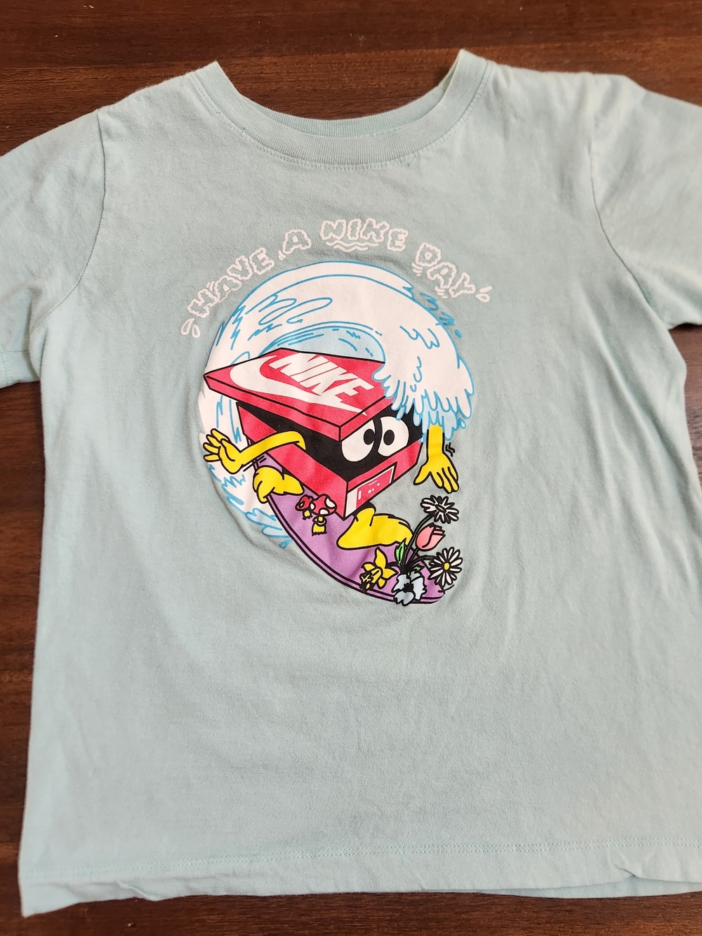 Nike Light Blue Kids Graphic Tee with Multicolor Surf Box Art